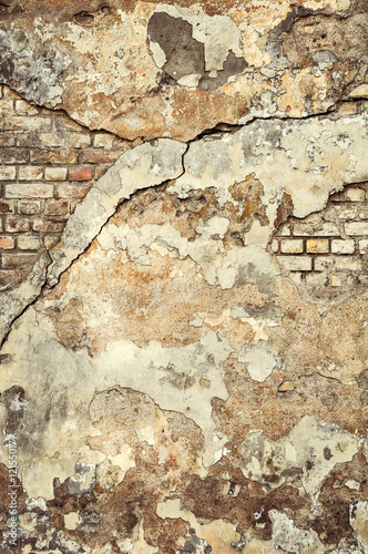Cracked, heavily damaged brick wall texture background