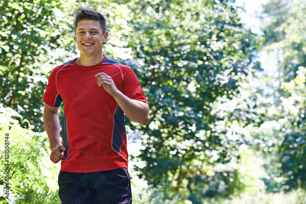Young Man Running Outdoors In Countryside Young Man Running Outdoors In Countryside