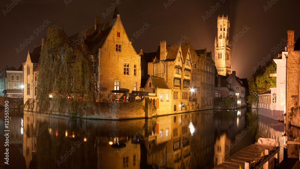Reflections in the canals of the medieval town of Bruges by night, Belgium