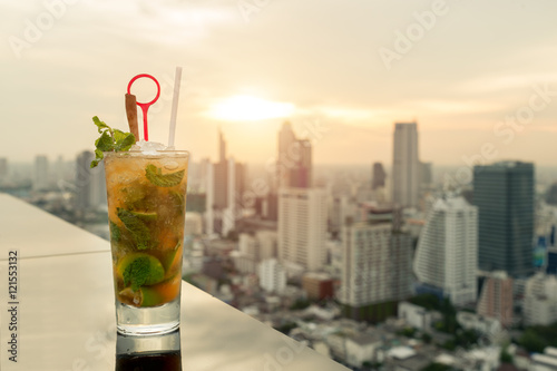 Photography Mojito cocktail on table in rooftop bar with Bangkok city