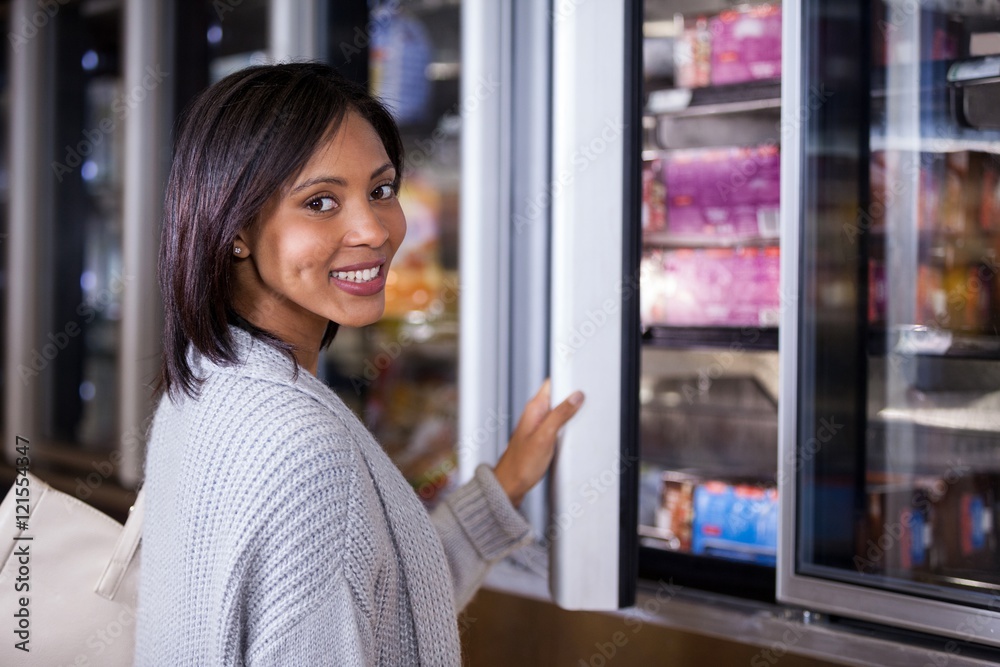 Woman standing near refrigerator Woman standing near refrigerator