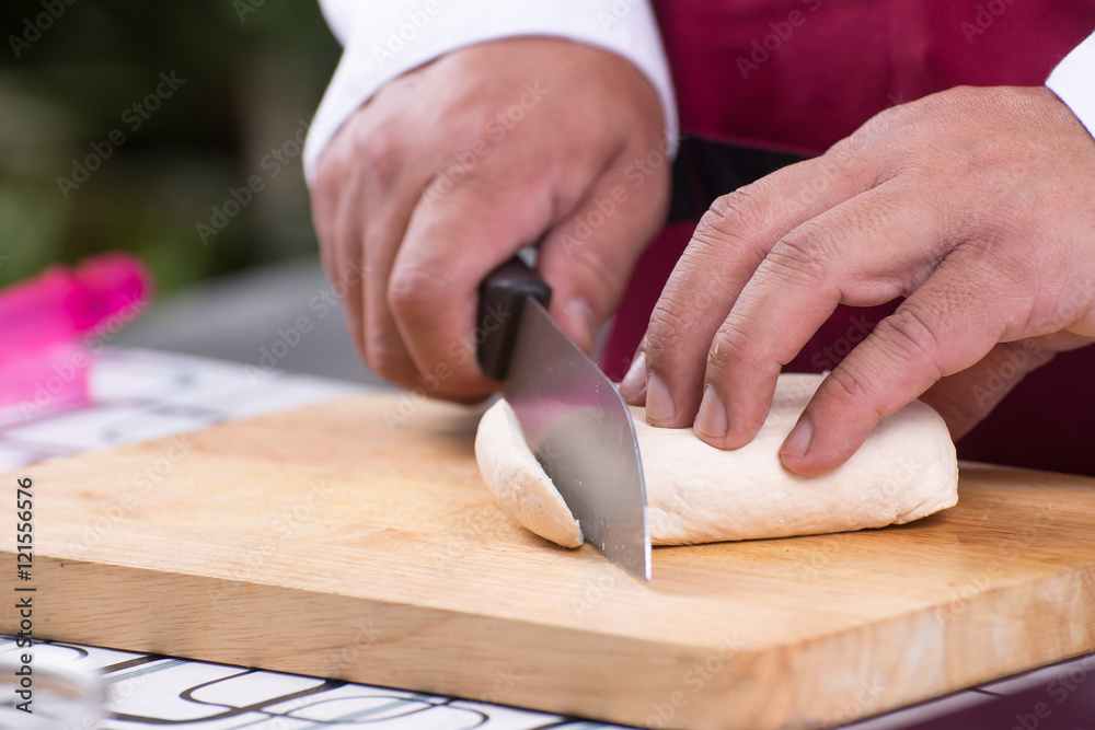 Chef slicing tofu for cooking Chef slicing tofu for cooking