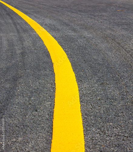 road Asphalt surface of the road with a yellow line.