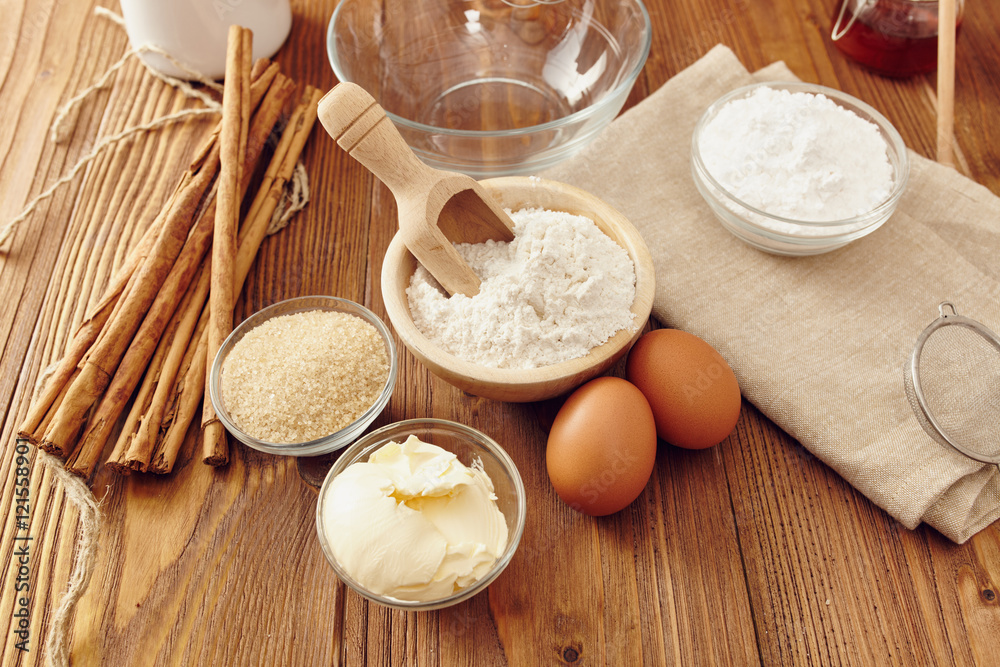 Fototapeta premium Ingredients to make a cake or a dessert on an aged wooden table