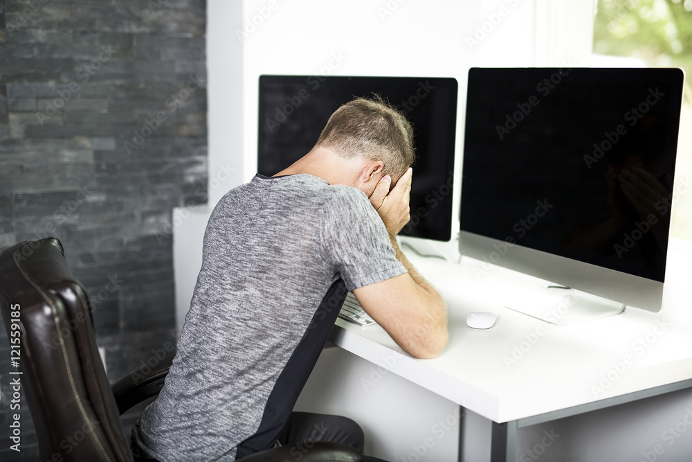 Young business man with problems and stress in the office