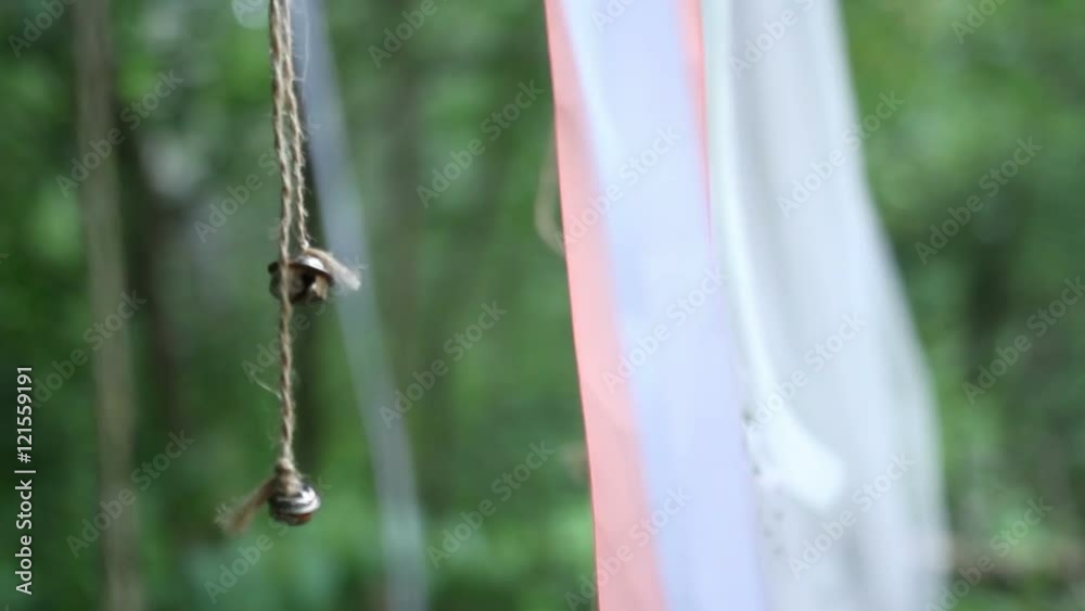 bell hanging on a ribbon in the wind