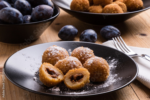 plum dumplings on black plate