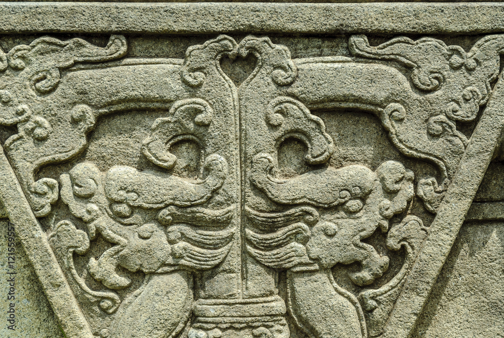 Dragons bas-reliefs in an ancient sculpture in the park ;Gardens by the ; of Singapore Dragons bas-reliefs in an ancient sculpture in the park ;Gardens by the ; of Singapore