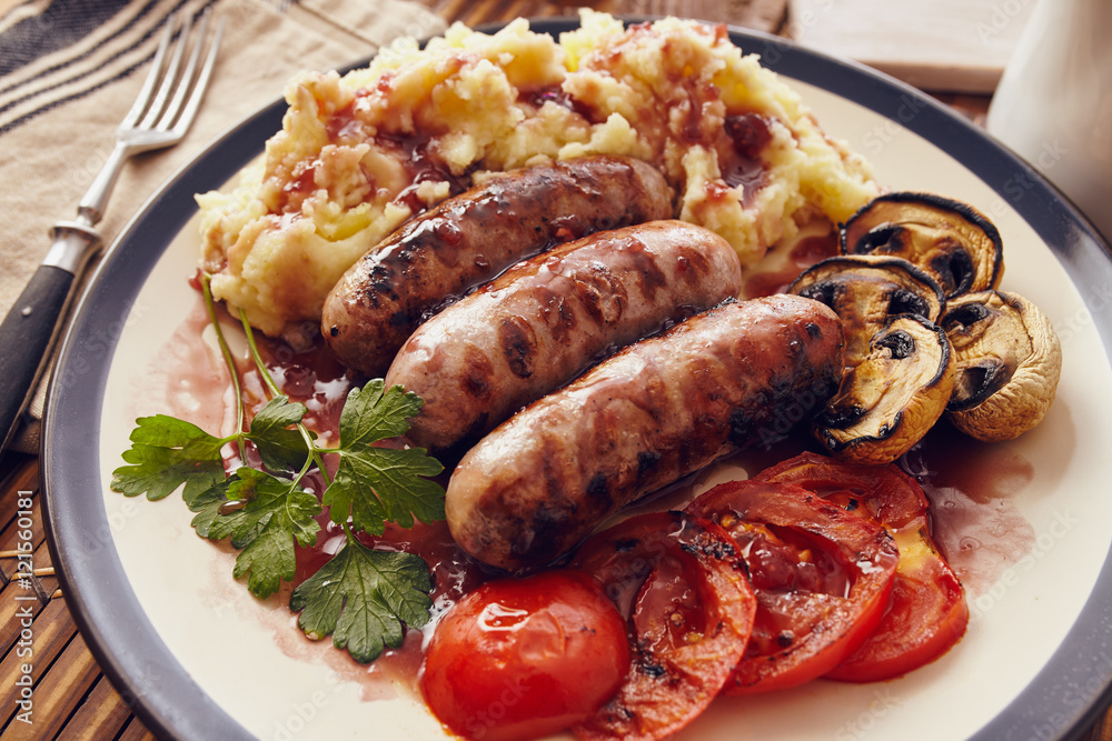 Sausage and mush dish with grilled mushrooms and tomatoes