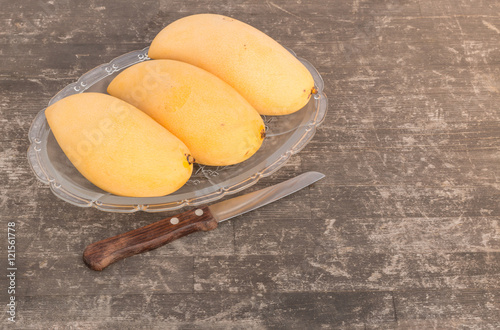  ripe mango on old pine wooden background