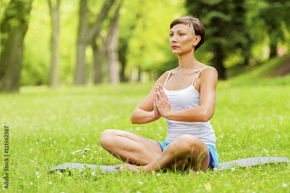 Woman doing yoga on the medow. Woman doing yoga on the medow.