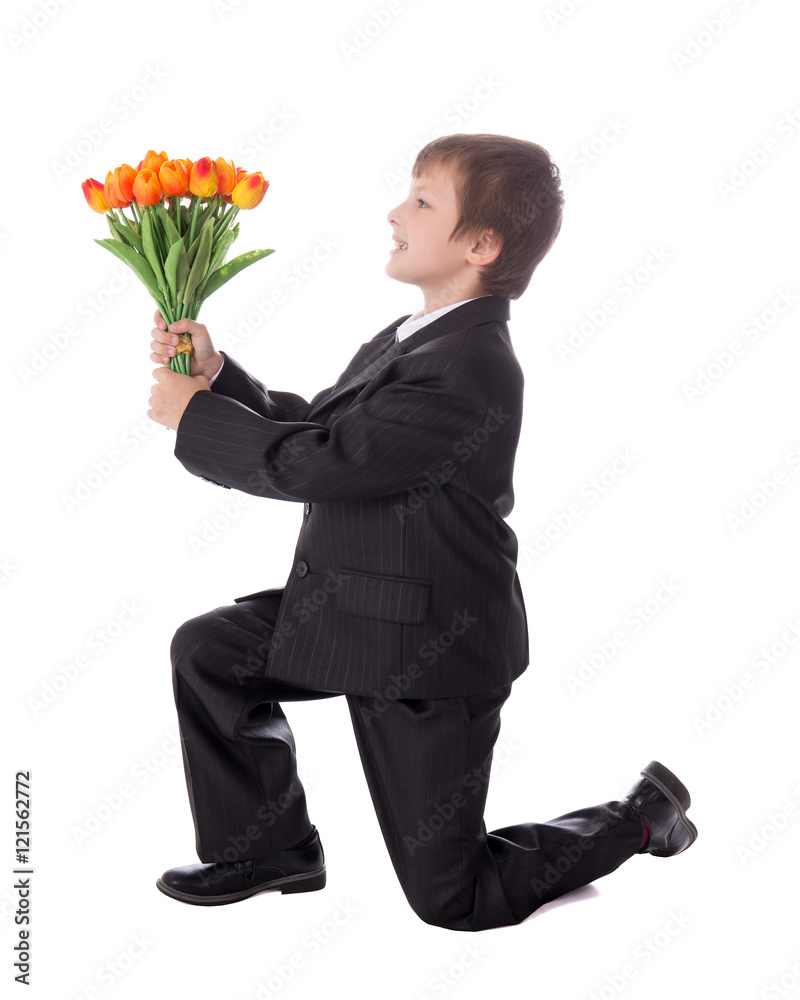 little boy in business suit giving flowers to somebody isolated little boy in business suit giving flowers to somebody isolated