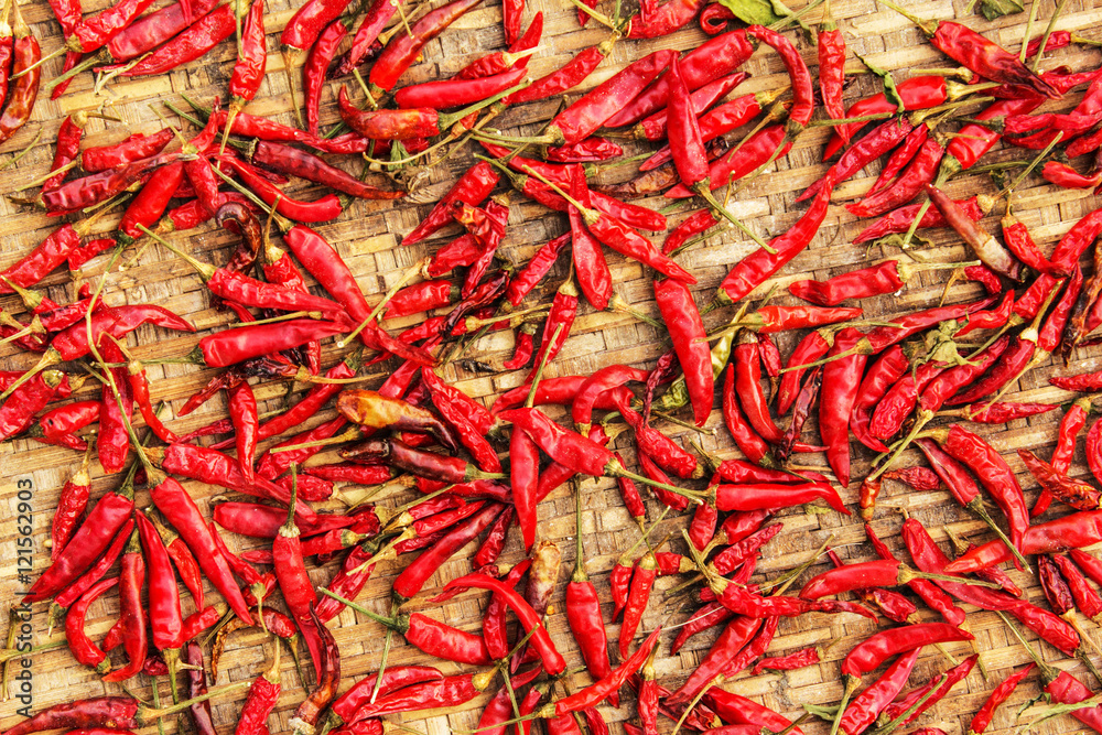 Red chili pepper dried. bamboo texture and background