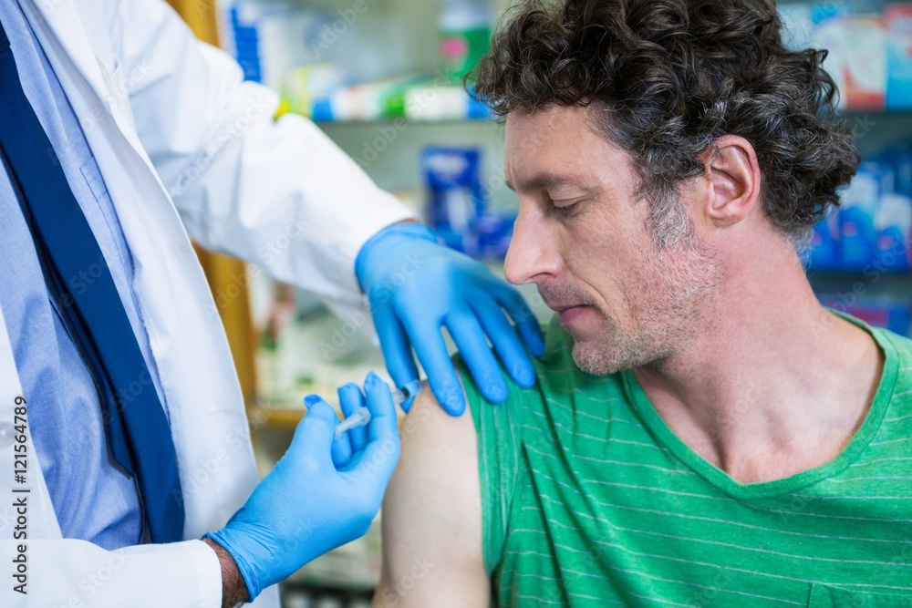 Pharmacist giving injection to patient Pharmacist giving injection to patient