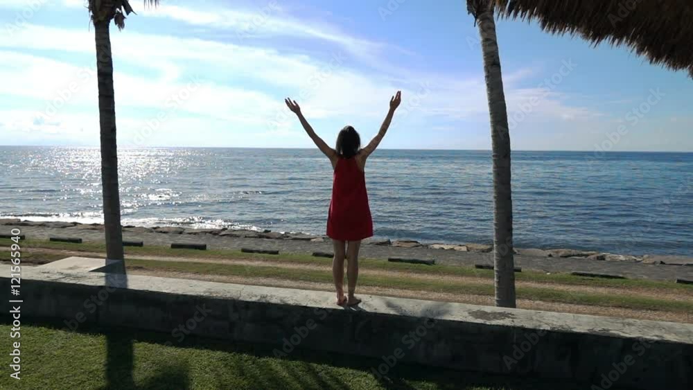 Young woman stretching her arms standing close to the sea, super slow motion
Young woman stretching her arms standing close to the sea, super slow motion