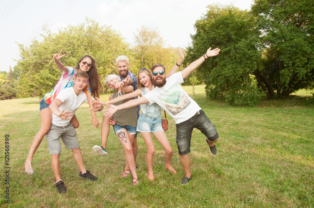 Group of friends having fun in a park on a sunny day