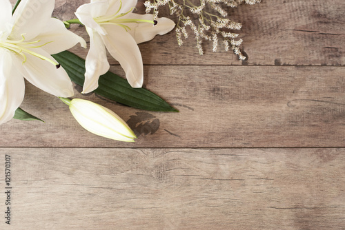 Fototapeta Naklejka Na Ścianę i Meble -  Floral frame with white calla, lilies on wooden background. Styled marketing photography. Copy space. Wedding, gift card, valentine's day or mothers day background