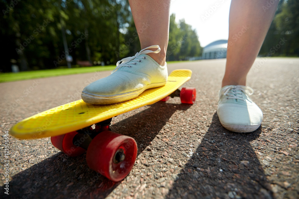 close up of female feet riding short skateboard close up of female feet riding short skateboard
