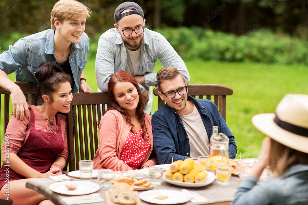happy friends having dinner at summer garden party