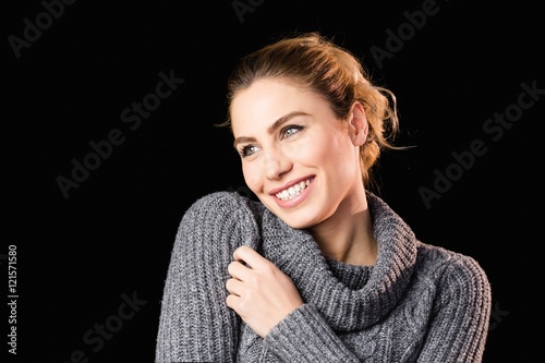 Beautiful woman posing against black background