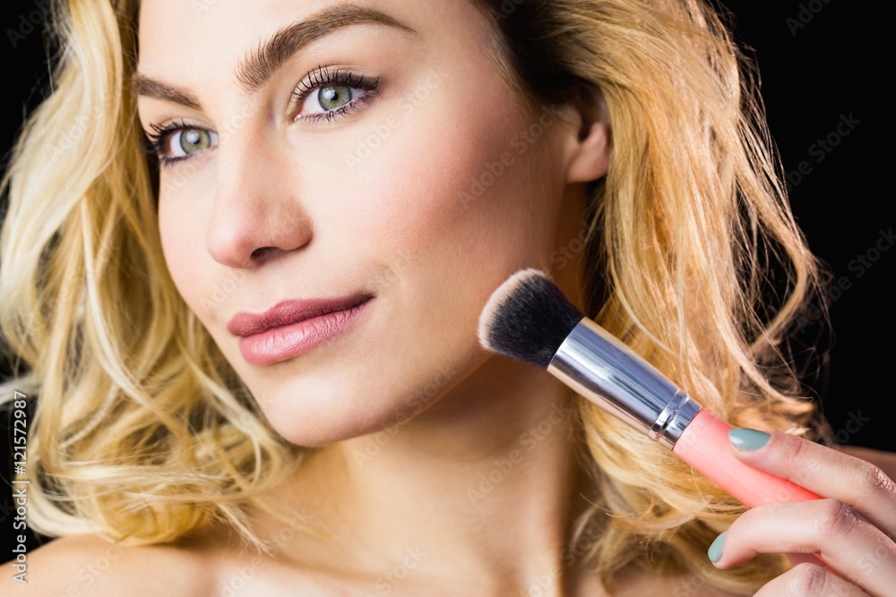 Beautiful woman posing with make-up brush Beautiful woman posing with make-up brush