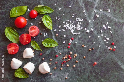 Ingredients for italian caprese salad with mozzarella, tomatoes and basil
