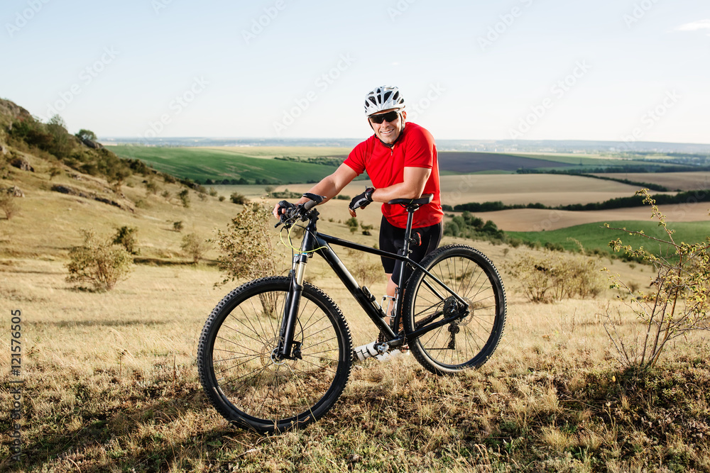 portrait of young cyclist with his mountain bike bicycle outdoors