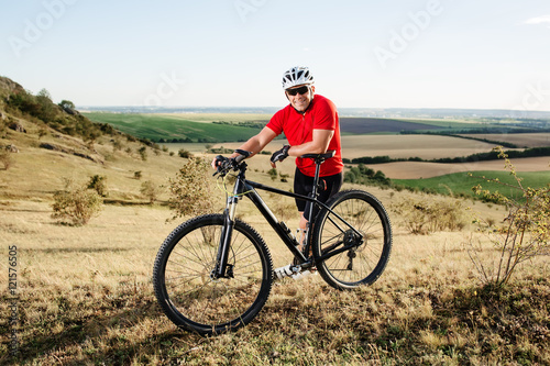 portrait of young cyclist with his mountain bike bicycle outdoors