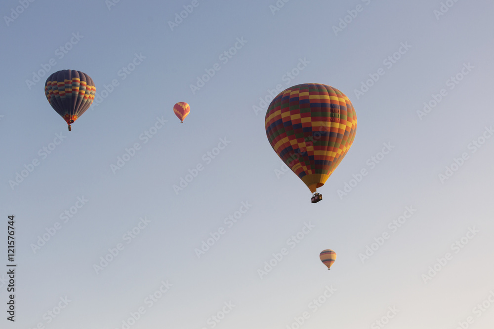 Fototapeta premium Hot air balloon flying over rock landscape at Cappadocia Turkey