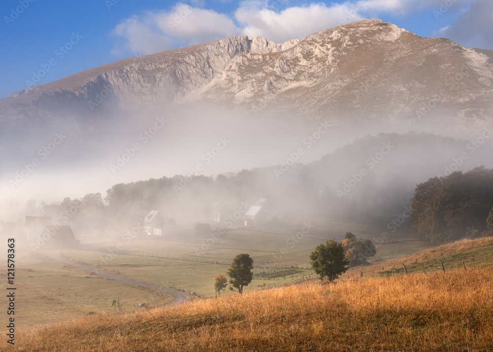Mountain landscape in autumn at beautiful misty morning