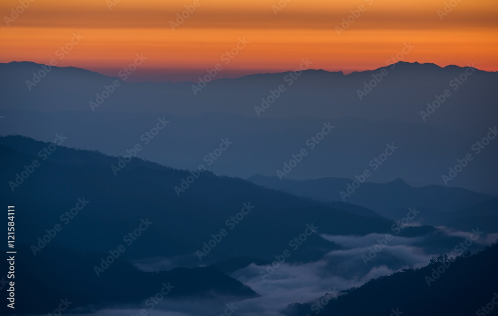 Beautiful sunrise scene with misty in morning in forest valley in Huay Nam Dang National Park. Chiang Mai, Thailand.