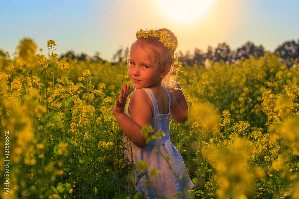 A little girl runs through a field of rape A little girl runs through a field of rape