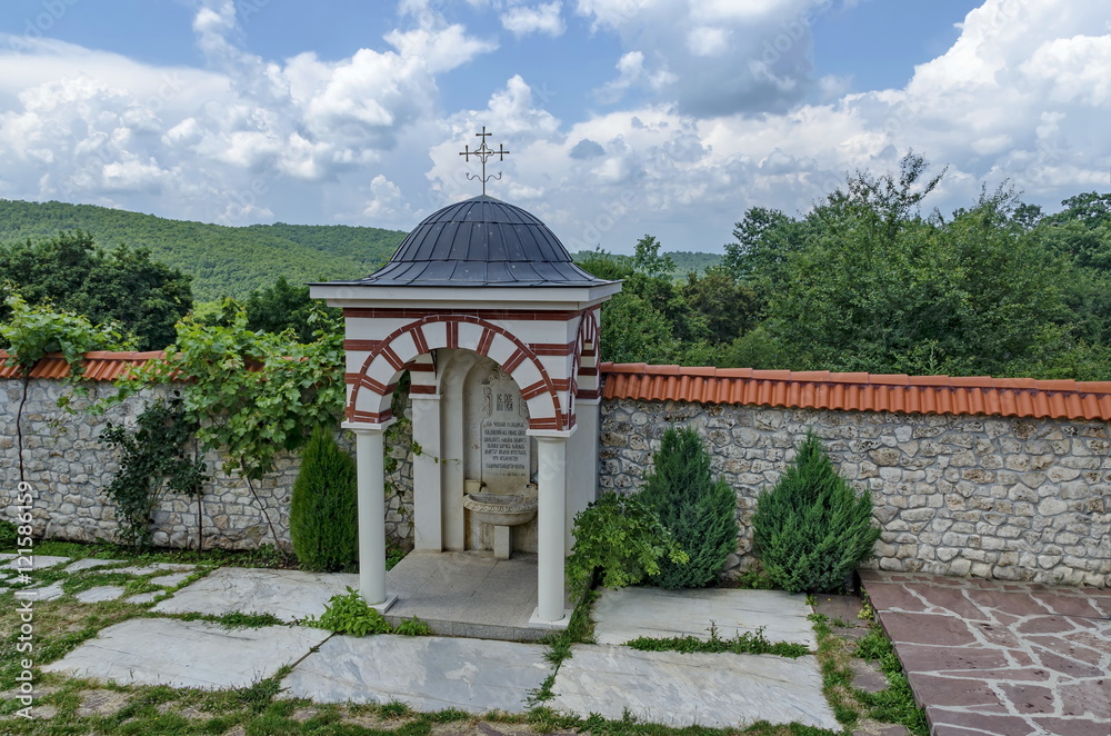 View of inner part yard with spring water fountain in restored Montenegrin or Giginski monastery St. St. Cosmas and Damian, mountain Kitka, Breznik, Pernik region, Bulgaria View of inner part yard with spring water fountain in restored Montenegrin or Giginski monastery St. St. Cosmas and Damian, mountain Kitka, Breznik, Pernik region, Bulgaria