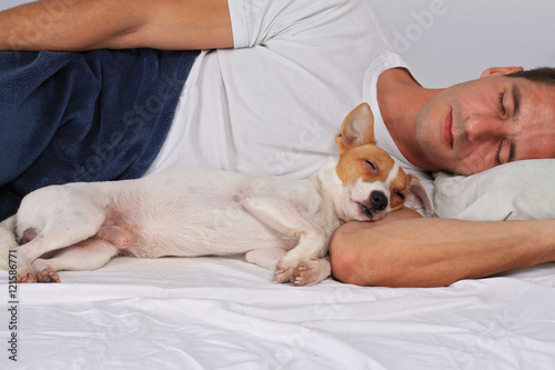 Man and dog sleeping together. Pet Allergies concept