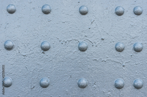 Bluish gray painted surface with rivet heads