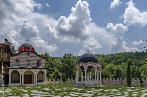 View of inner  part yard with new monastic house, alcove  and new church, in restored Montenegrin or Giginski monastery  St. St. Cosmas and Damian, mountain  Kitka, Breznik, Pernik region, Bulgaria  photo