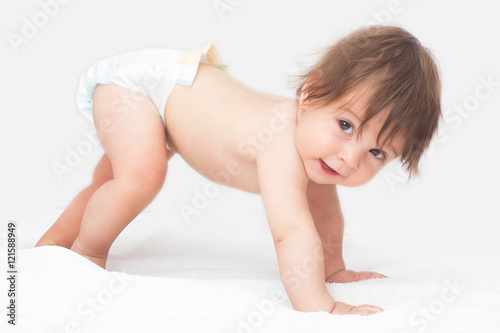 Bright picture of crawling baby girl in diaper.