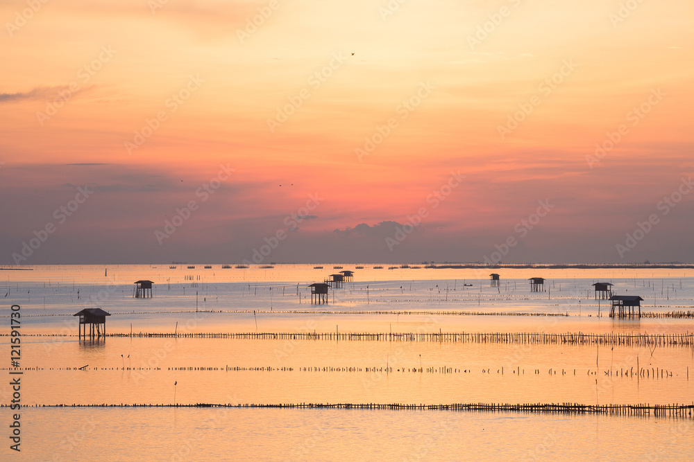 Fototapeta premium sunrise over fisherman village by the sea