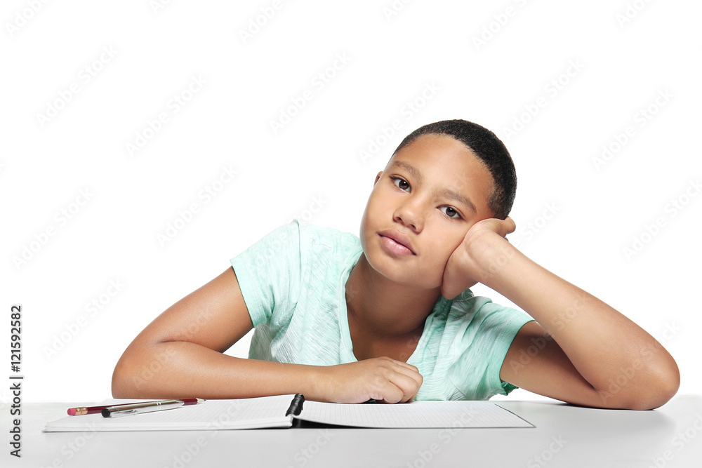 African American boy making homework on light background African American boy making homework on light background