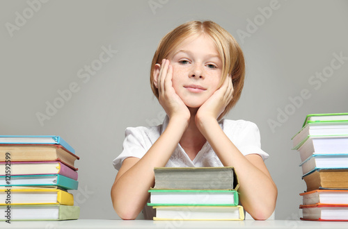 Cute girl with books on gre...