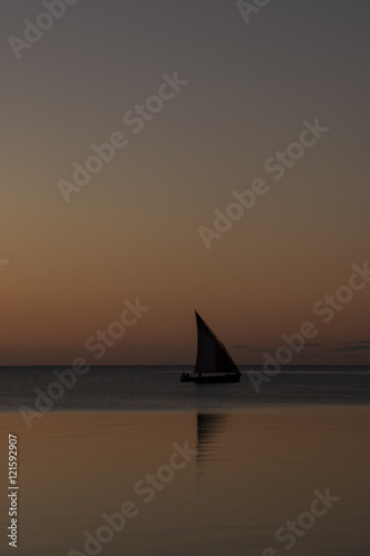 Dhow sailing over the sunset at Bazaruto Island, Mozambique