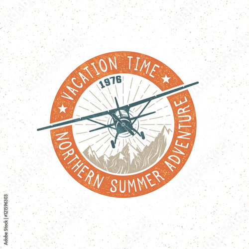 Retro adventure logo, emblem, badge with a light aircraft flying over mountains. Vector illustration. Grunge texture and background on separate layers.