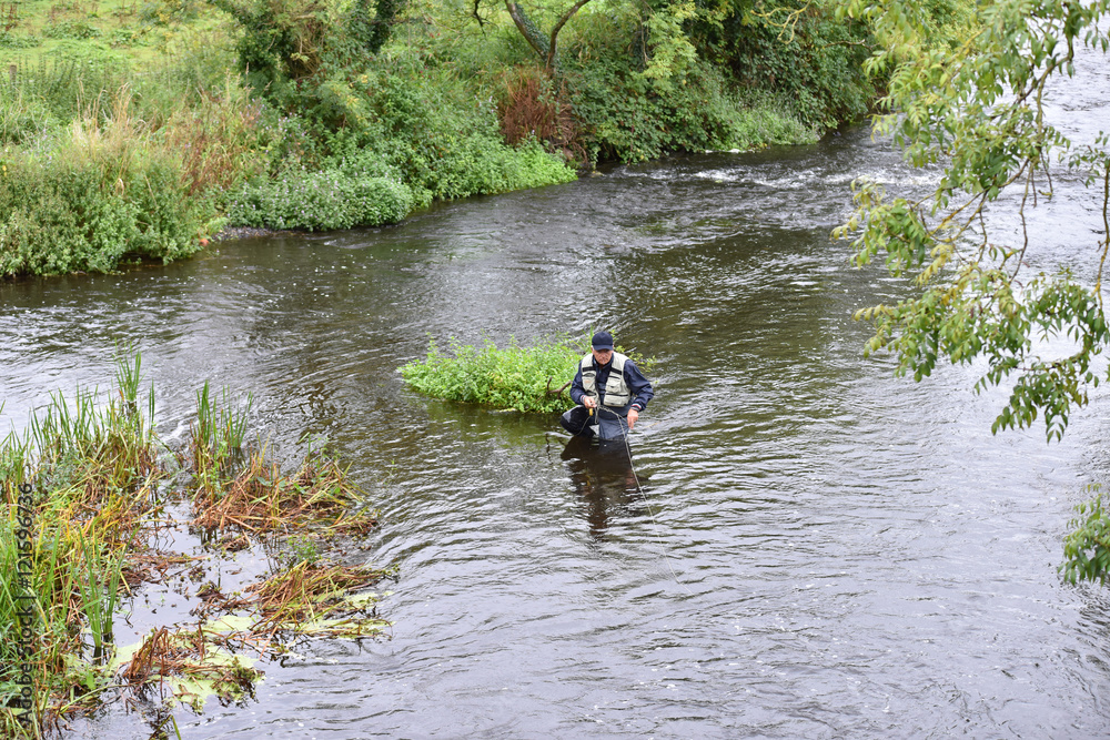 Upper view of fly fisherman fishing in river Upper view of fly fisherman fishing in river
