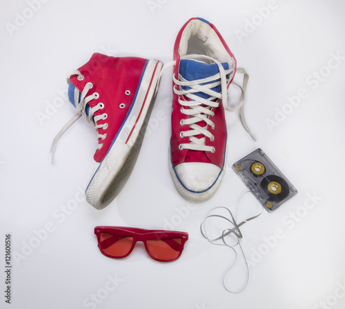 Old red sneakers, red glasses and tape
