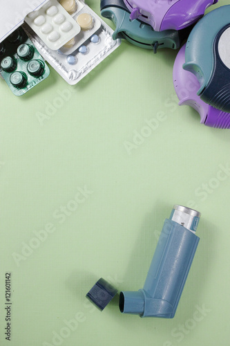 Asthma, allergy, illness relief concept, salbutamol inhalers and drugs on light green background