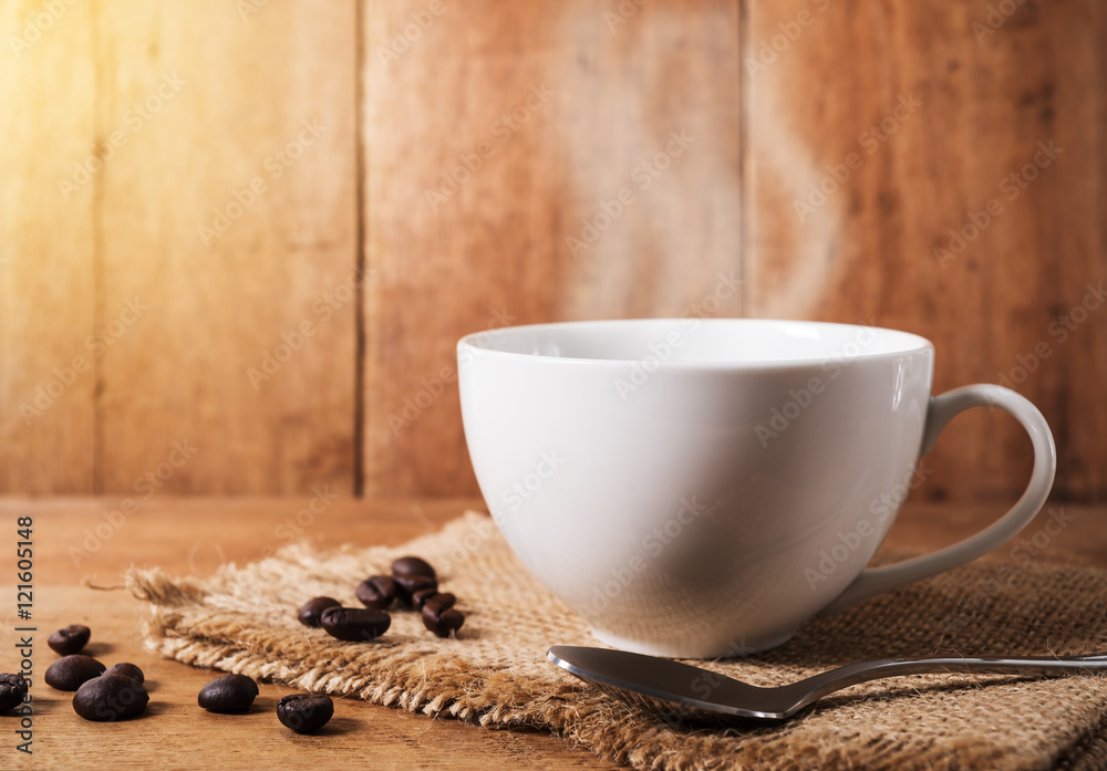 Coffee cup with coffee bean on brown table Coffee cup with coffee bean on brown table