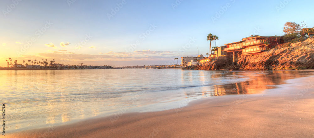 Sunset over the harbor in Corona del Mar, California at the beach in the United States - obrazy, fototapety, plakaty 