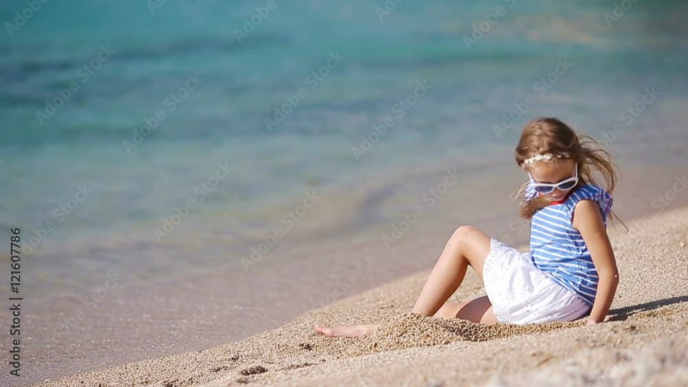 Adorable little girl at tropical beach during vacation Adorable little girl at tropical beach during vacation