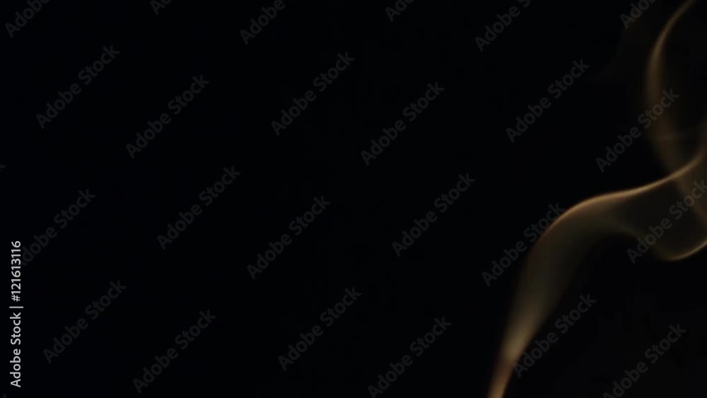 Beautiful wisp of smoke on a black background. Warm tone Beautiful wisp of smoke on a black background. Warm tone
