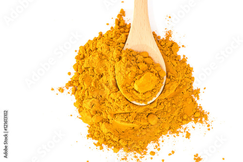 Turmeric powder in wood spoon on white background photo